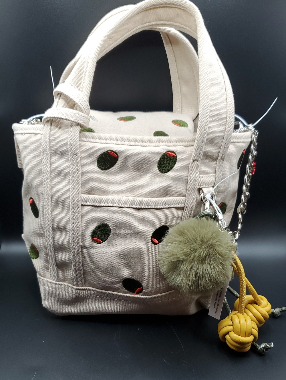 Madden Girl Canvas Mini Tote Bag with Olive Dot Embroidery and Pom Charm